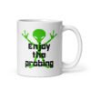 White ceramic coffee mug with an image of a green alien and the text 'Enjoy the probing' printed on both sides of the mug.