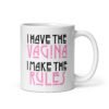 White ceramic coffee mug with the text 'I have the vagina. I make the rules' printed on both sides.