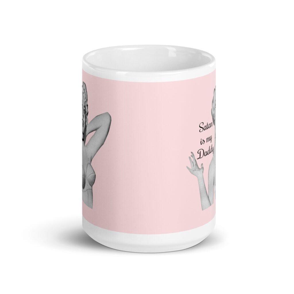 Pink and white ceramic coffee mug with an image of a retro black & white pin-up model and the text 'Satan is my Daddy' printed on both sides.