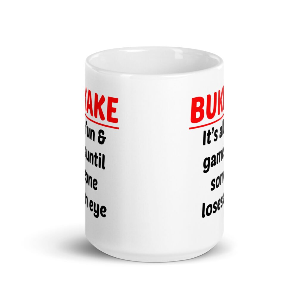 White ceramic mug with the text 'Bukkake. It's all fun & games until someone loses an eye' printed on both sides.