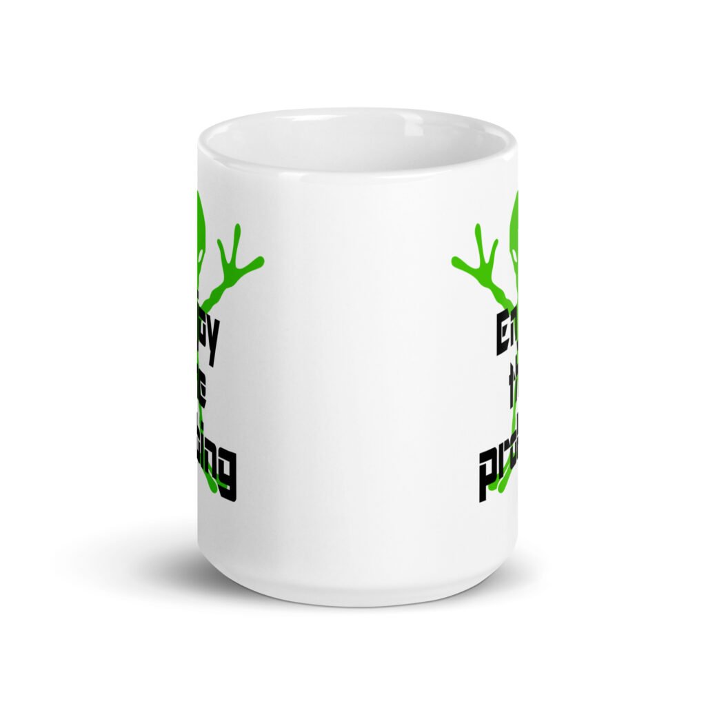 White ceramic coffee mug with an image of a green alien and the text 'Enjoy the probing' printed on both sides of the mug.