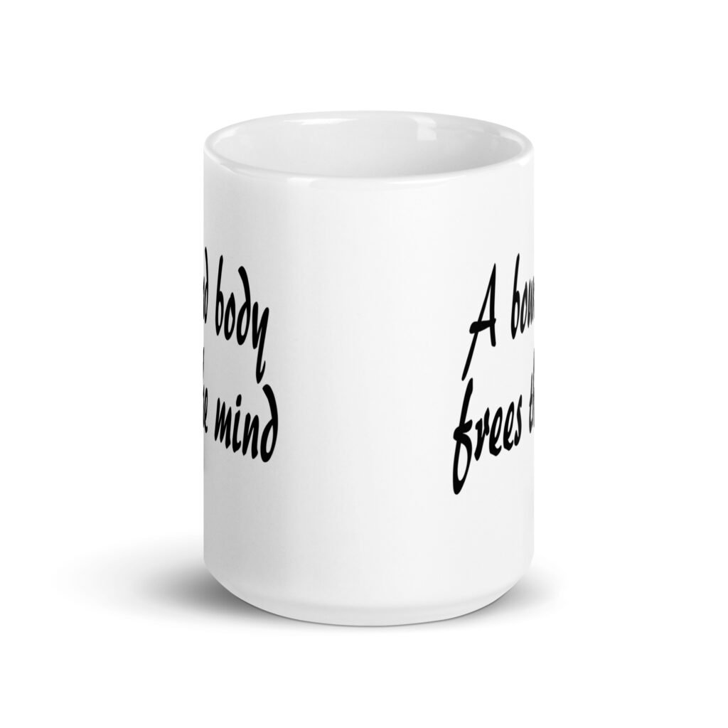 White ceramic coffee mug with the text 'A bound body frees the mind' printed on both sides.