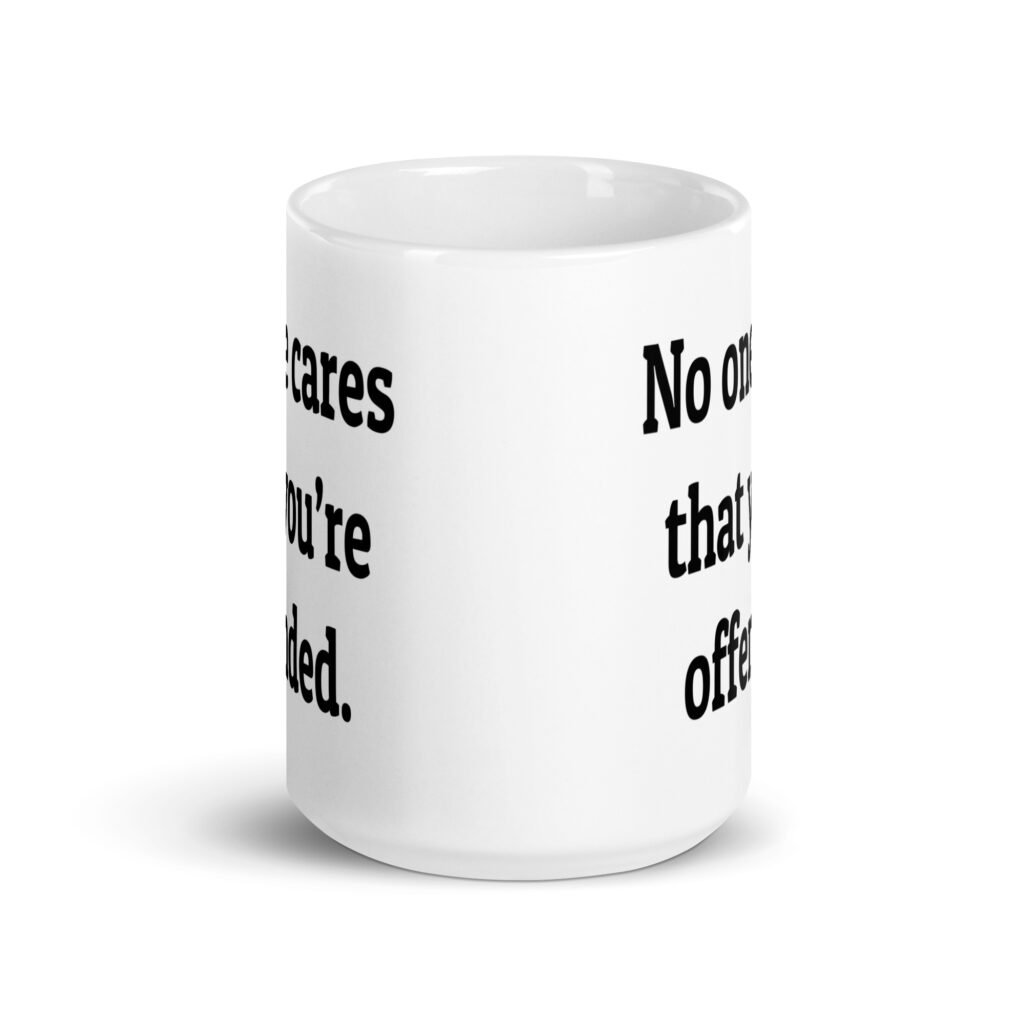 White ceramic coffee mug with the text "No one cares that you're offended.' printed on both sides.