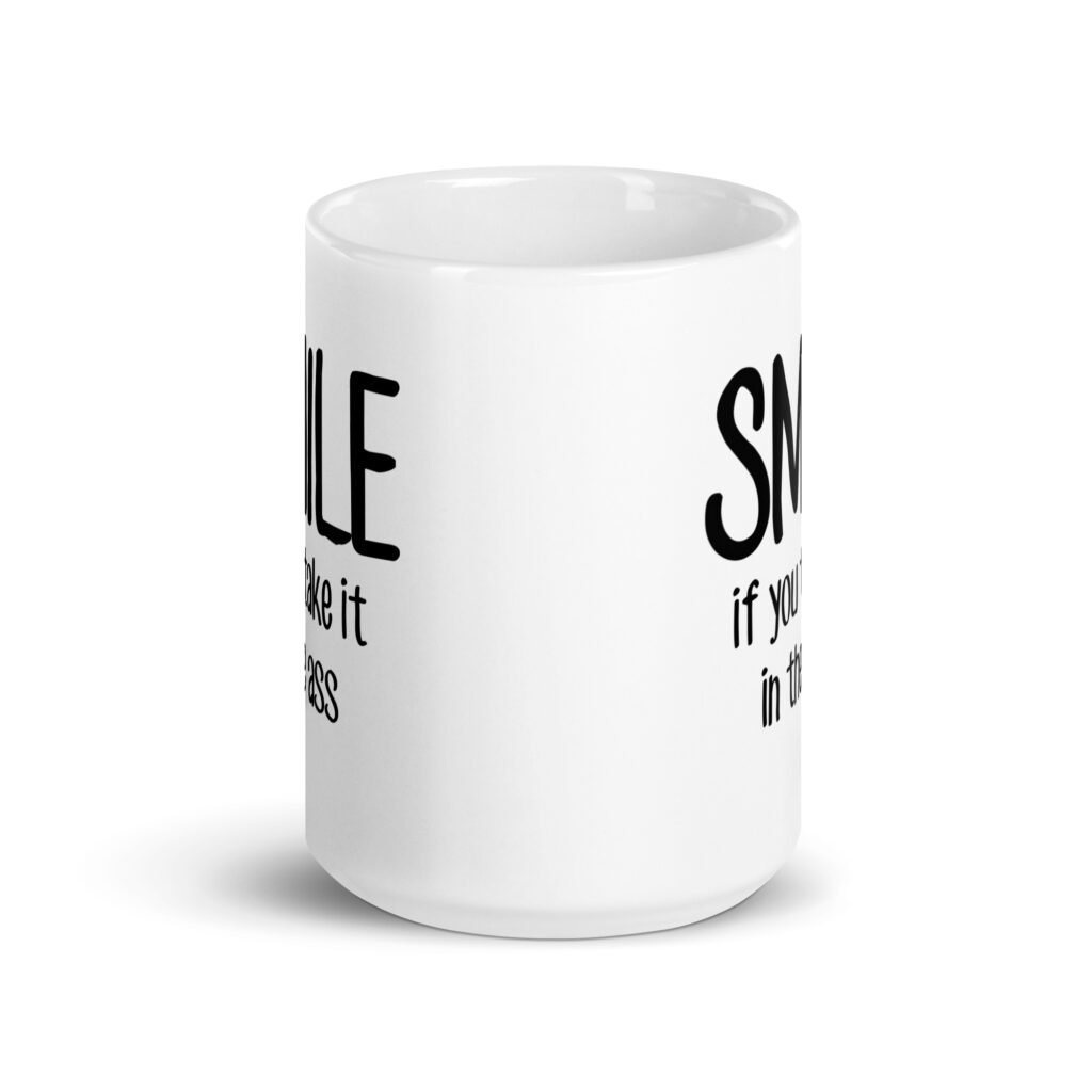 White ceramic mug with the text 'Smile if you take it in the ass' printed on both sides. The word 'smile' is large and the words 'take it in the ass' are much smaller.