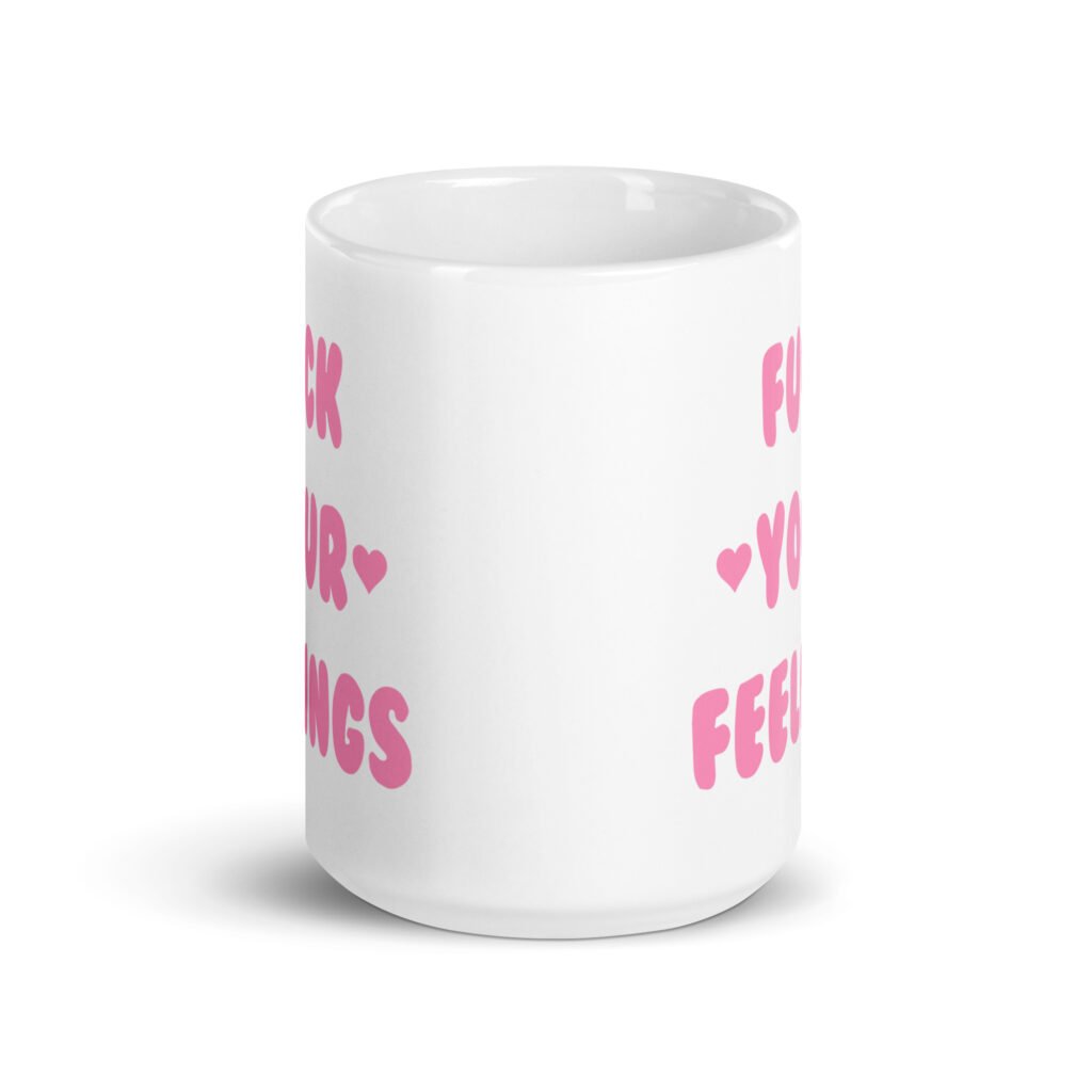White ceramic coffee mug with the text 'Fuck your feelings' printed on both sides in pink. There are cute pink hearts next to the words.