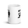 White ceramic mug with graphic of collared and leashed man on his hands and knees being led by a woman and the text 'Boss Lady' printed on both sides.