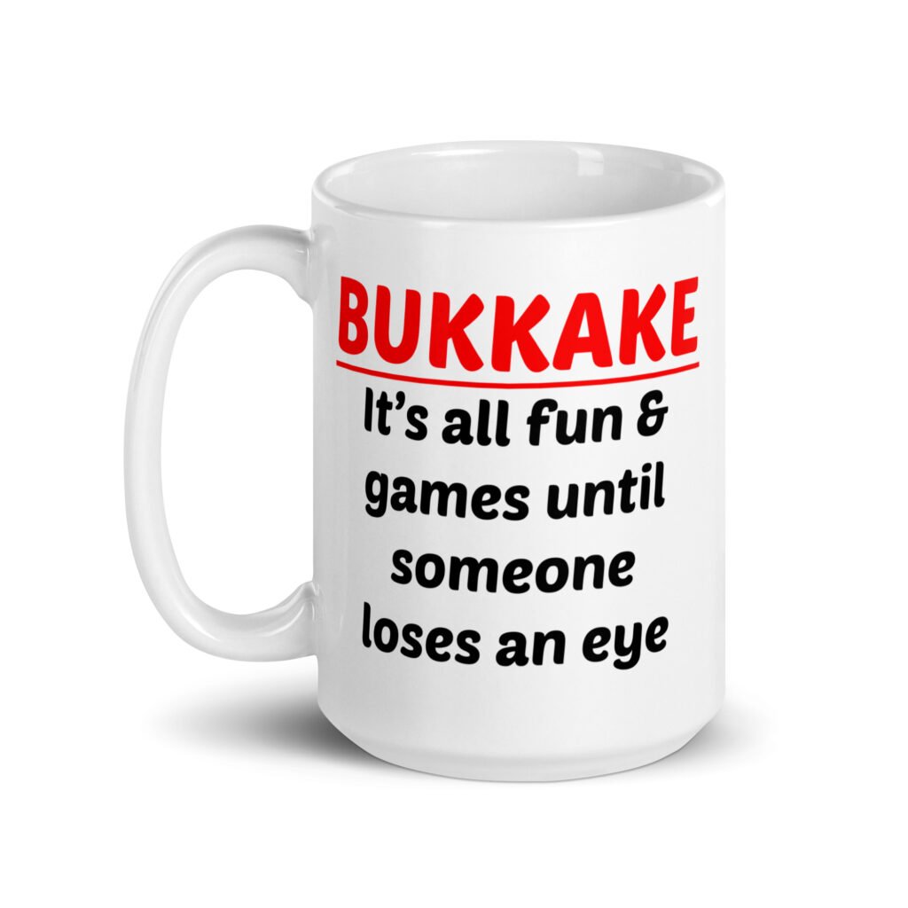 White ceramic mug with the text 'Bukkake. It's all fun & games until someone loses an eye' printed on both sides.