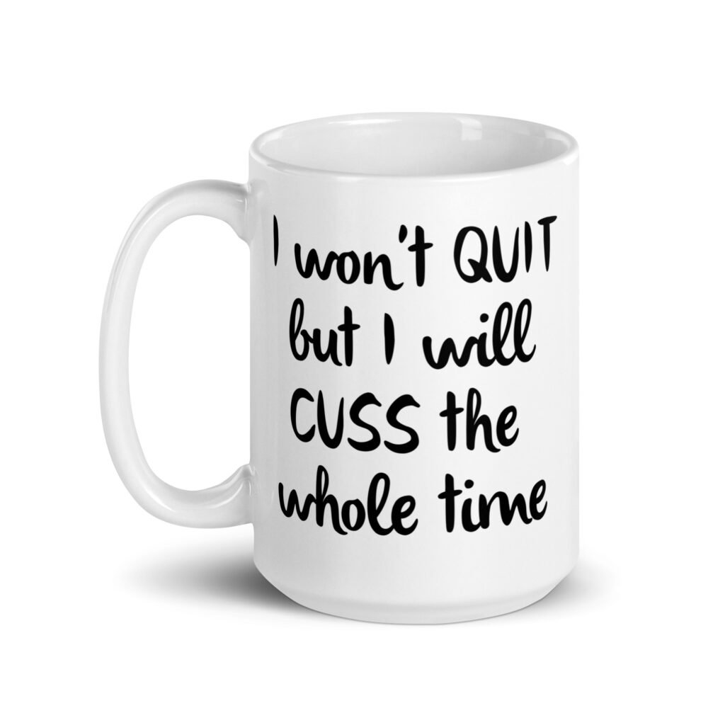 White ceramic coffee mug with the text 'I won't QUIT but I will CUSS the whole time' printed on both sides.