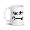 White ceramic coffee mug with an image of a key and the word 'Daddy' printed on both sides.