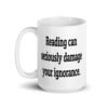 White ceramic coffee mug with the text 'Reading can seriously damage your ignorance.' printed on both sides.