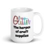 White ceramic coffee mug with the text 'Glitter the herpes of craft supplies' printed on both sides. The word Glitter is printed in multi colored font that looks like glitter.