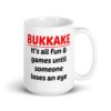 White ceramic mug with the text 'Bukkake. It's all fun & games until someone loses an eye' printed on both sides.