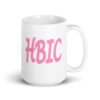 White ceramic coffee mug with the acronym 'HBIC' printed on both sides in pink.