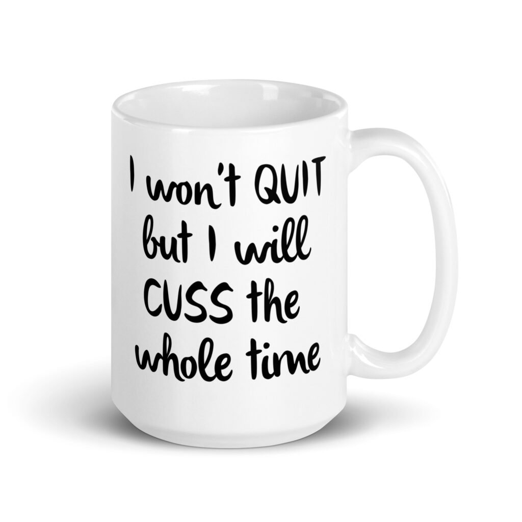 White ceramic coffee mug with the text 'I won't QUIT but I will CUSS the whole time' printed on both sides.