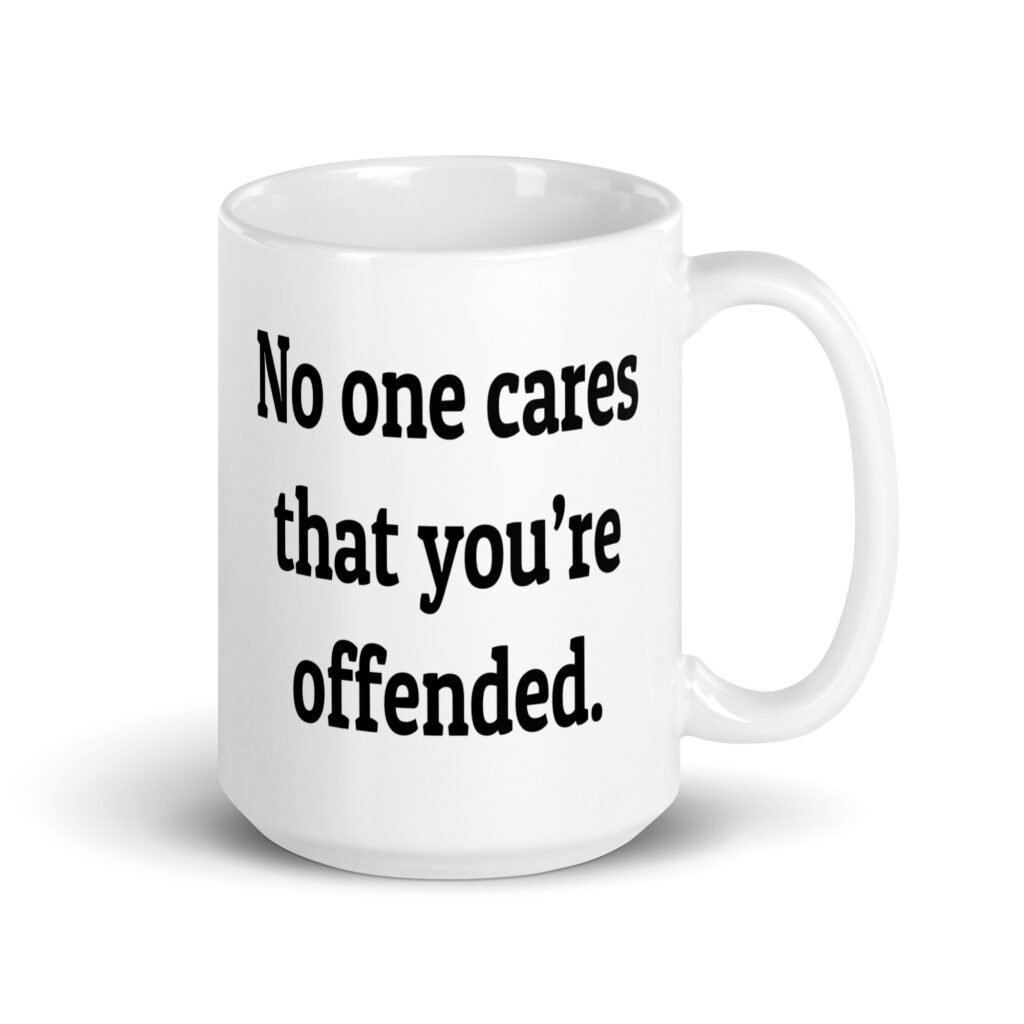 White ceramic coffee mug with the text "No one cares that you're offended.' printed on both sides.