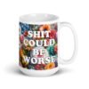 White ceramic mug floral background and the text 'Shit could be worse' printed on both sides.