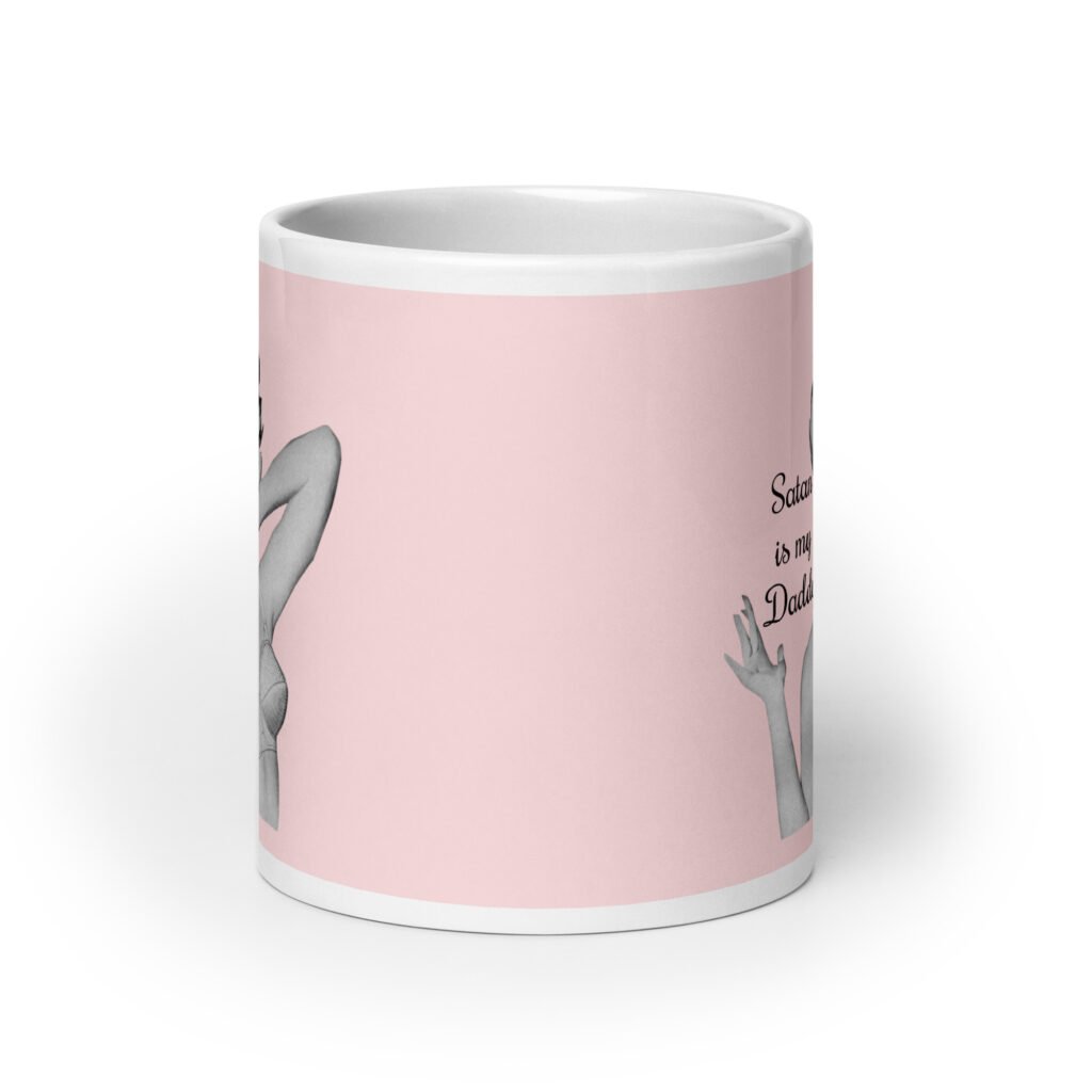 Pink and white ceramic coffee mug with an image of a retro black & white pin-up model and the text 'Satan is my Daddy' printed on both sides.