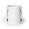 White ceramic coffee mug with an image of a green alien and the text 'Enjoy the probing' printed on both sides of the mug.