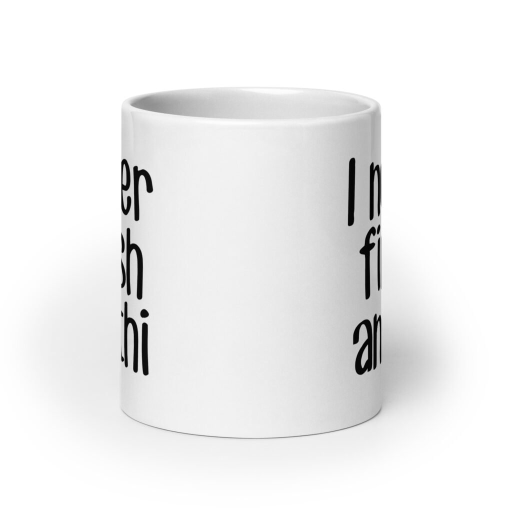 White ceramic coffee mug with the text 'I never finish anyth' printed on both sides.