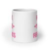 White ceramic coffee mug with the text 'Fuck your feelings' printed on both sides in pink. There are cute pink hearts next to the words.