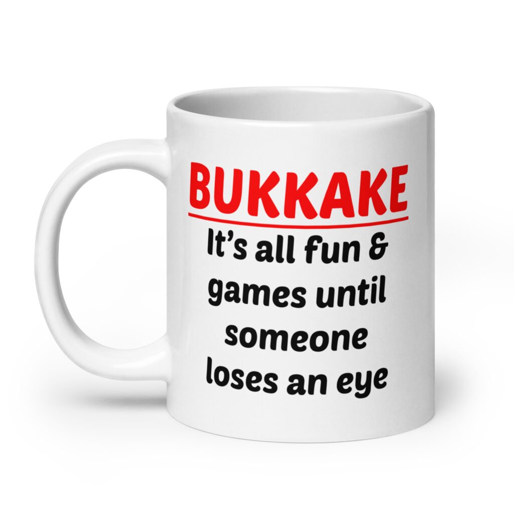 White ceramic mug with the text 'Bukkake. It's all fun & games until someone loses an eye' printed on both sides.
