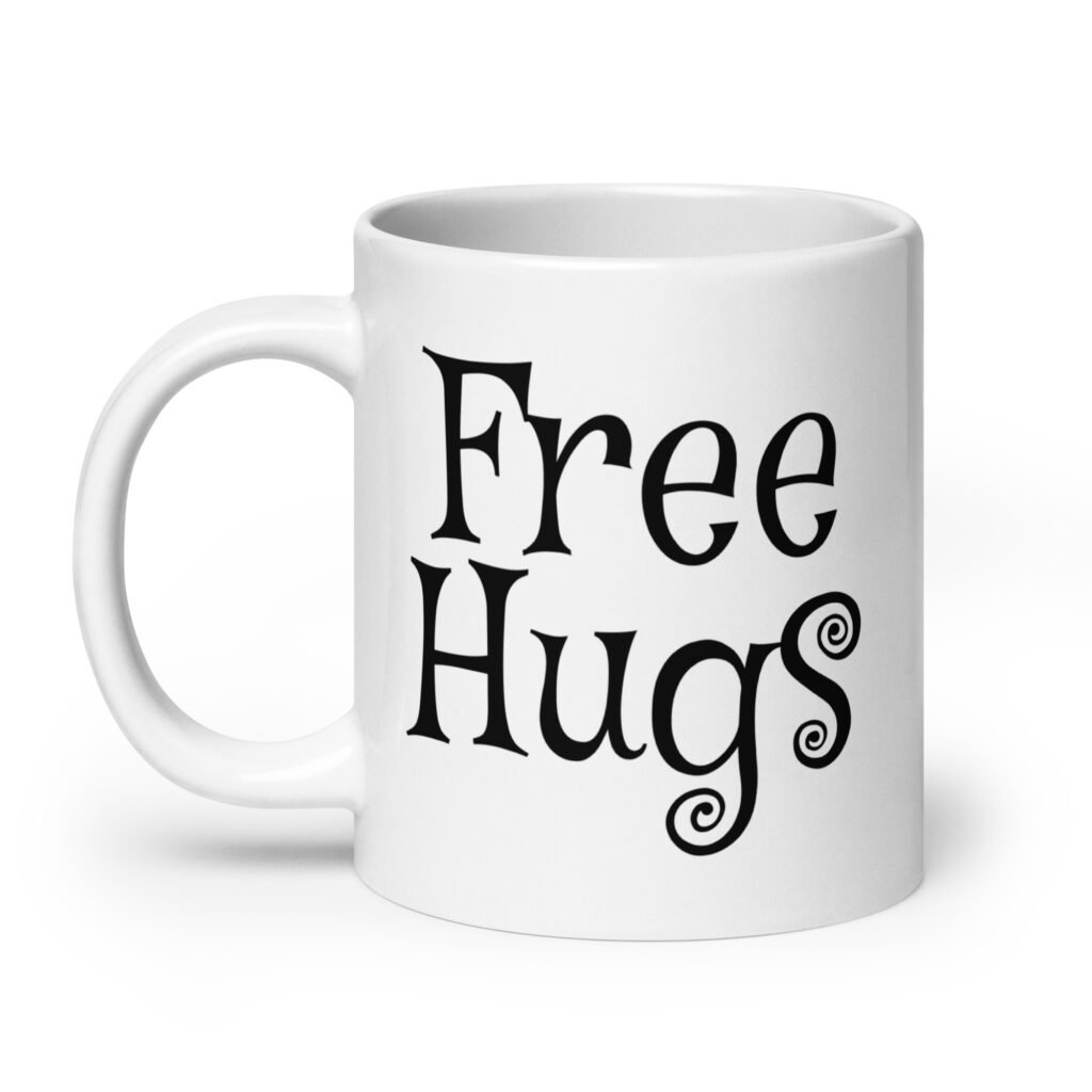 White ceramic coffee mug with the text 'Free Hugs' printed on both sides.