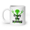 White ceramic coffee mug with an image of a green alien and the text 'Enjoy the probing' printed on both sides of the mug.