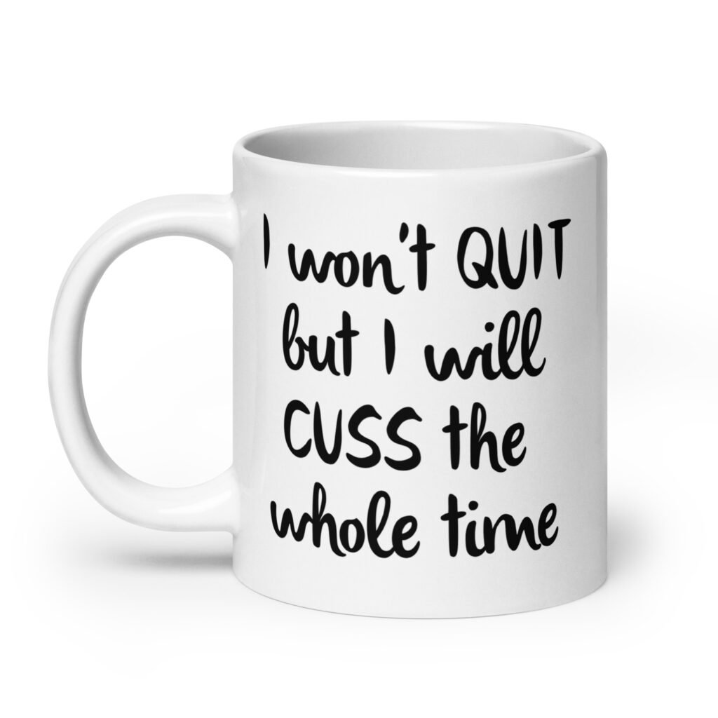 White ceramic coffee mug with the text 'I won't QUIT but I will CUSS the whole time' printed on both sides.