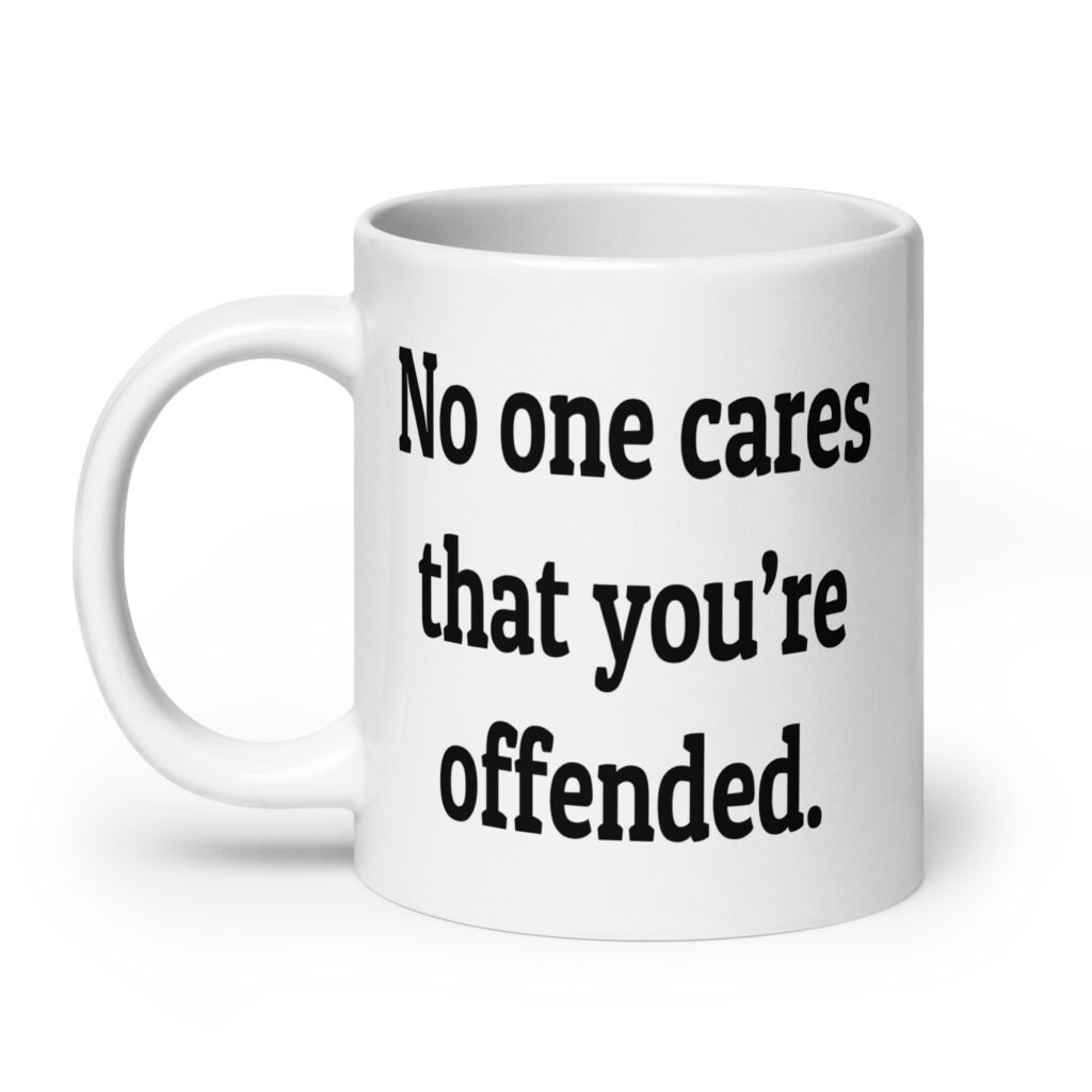 White ceramic coffee mug with the text "No one cares that you're offended.' printed on both sides.