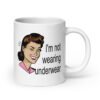 White ceramic coffee mug with an image of a retro woman and the text 'I'm not wearing underwear' printed on both sides.
