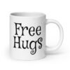 White ceramic coffee mug with the text 'Free Hugs' printed on both sides.