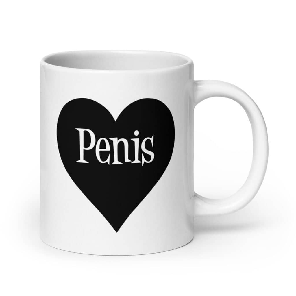 White ceramic coffee mug with a heart image printed on both sides. The word 'Penis' is inside the heart.