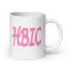 White ceramic coffee mug with the acronym 'HBIC' printed on both sides in pink.