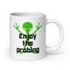 White ceramic coffee mug with an image of a green alien and the text 'Enjoy the probing' printed on both sides of the mug.