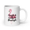White ceramic coffee mug with an image of a flamingo and the text 'Single & ready to flamingle' printed on both sides.
