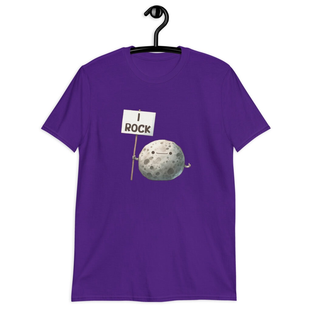 Purple t-shirt that has an image of a grey rock that is holding a sign. The sign says 'I Rock.' The image is printed on the front of the shirt.