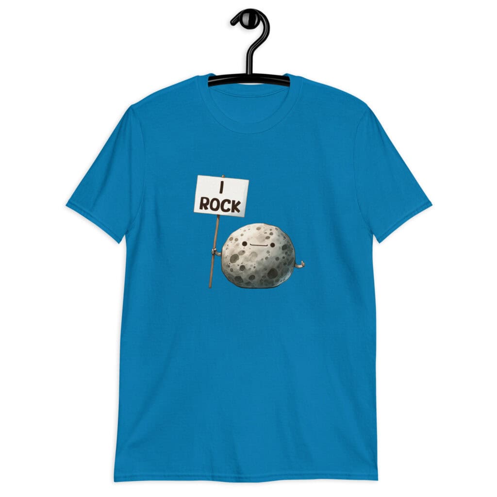 Sapphire blue t-shirt that has an image of a grey rock that is holding a sign. The sign says 'I Rock.' The image is printed on the front of the shirt.