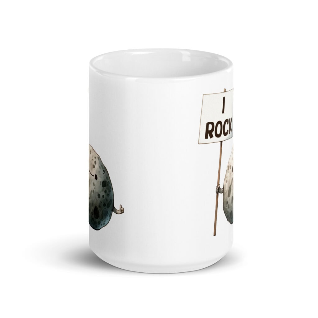 White ceramic mug that has an image of a grey rock that is holding a sign. The sign says 'I Rock.' The image is printed on both sides of the mug.