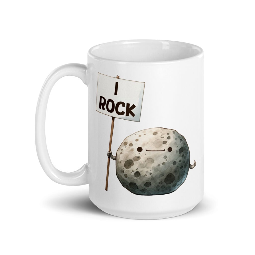 White ceramic mug that has an image of a grey rock that is holding a sign. The sign says 'I Rock.' The image is printed on both sides of the mug.