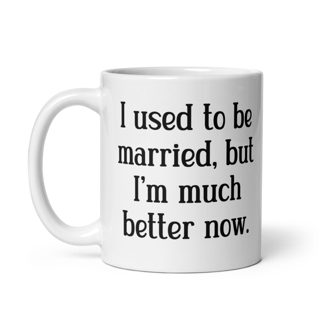 White ceramic mug with with the text "I used to be married, but I'm much better now" printed on both sides.