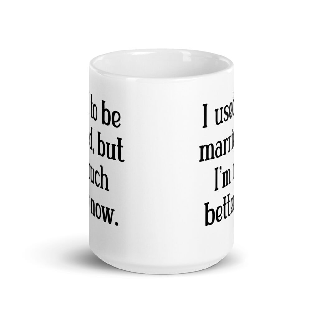 White ceramic mug with with the text "I used to be married, but I'm much better now" printed on both sides.