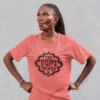 Woman wearing a coral color with the text "The clitoris is not a pacifier" printed on the front.