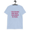 Light blue t-shirt with the text 'The boobs are real, the smile is fake.' printed in pink on the front.