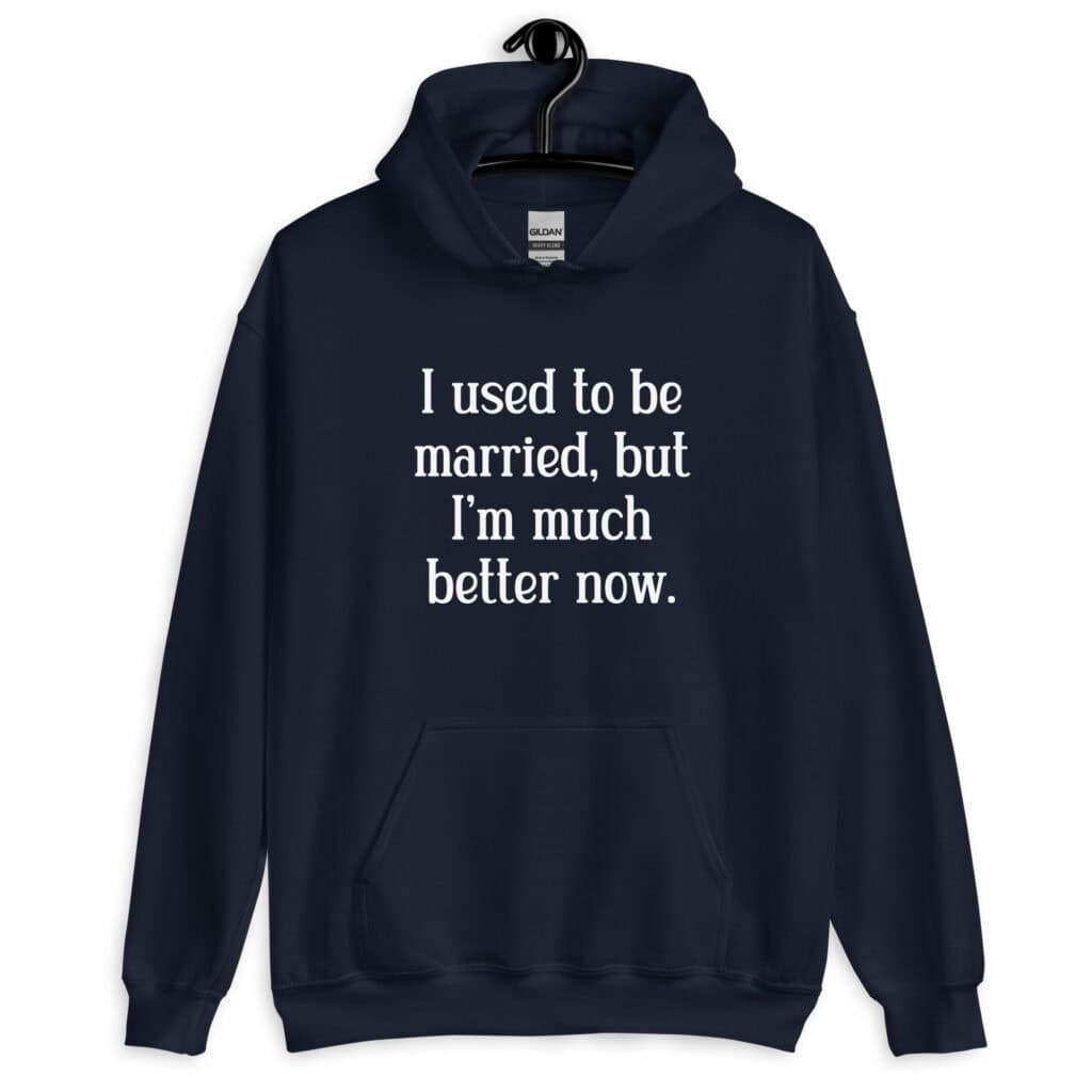 Navy blue hoodie sweatshirt with the text "I used to be married, but I'm much better now" printed on the front.