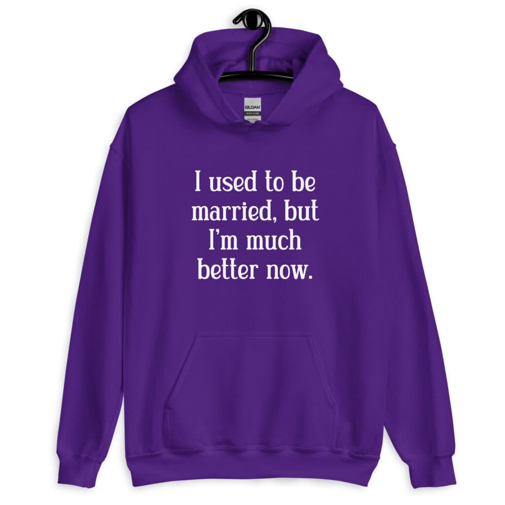 Purple hoodie sweatshirt with the text "I used to be married, but I'm much better now" printed on the front.