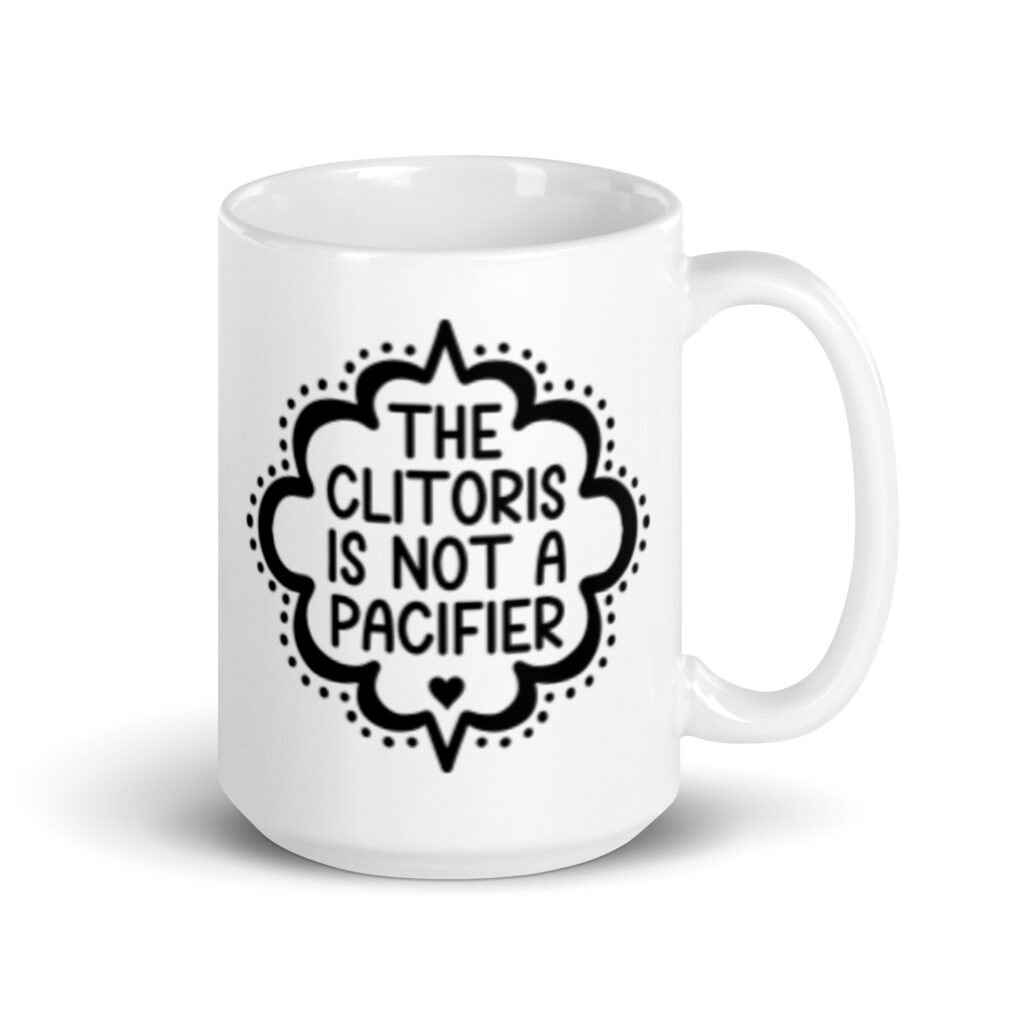 White ceramic mug with the text "The clitoris is not a pacifier" printed on both sides.