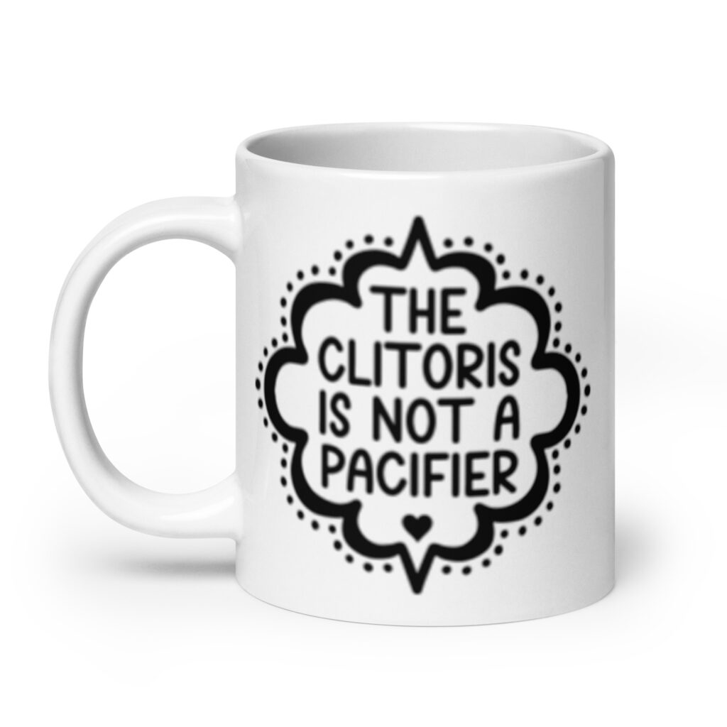 White ceramic mug with the text "The clitoris is not a pacifier" printed on both sides.