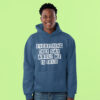 Winking man wearing an indigo blue hoodie sweatshirt with the text 'Everything they say about me is true' printed on the front.