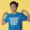 Winking man wearing a sapphire blue t-shirt with the text 'Everything they say about me is true' printed on the front.