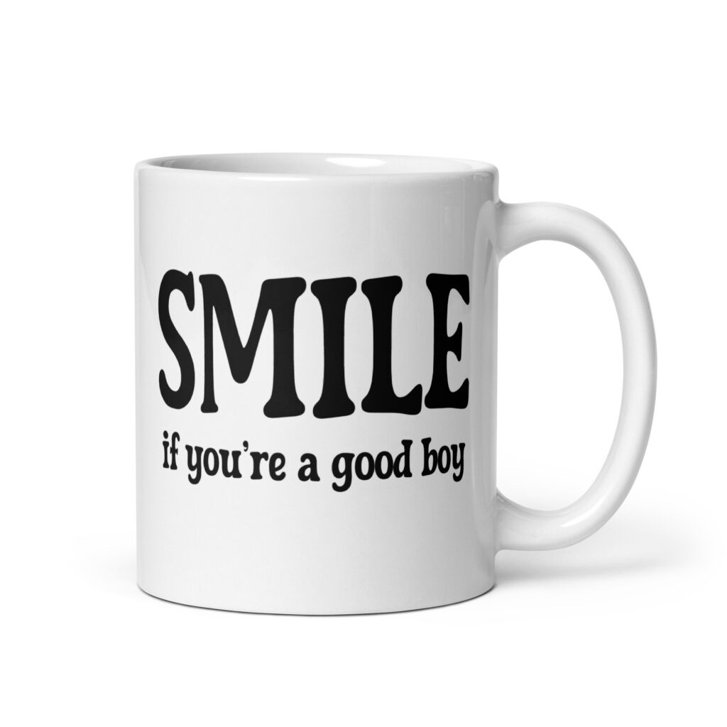 White ceramic mug with the text 'SMILE if you're a good boy' printed on both sides in black,